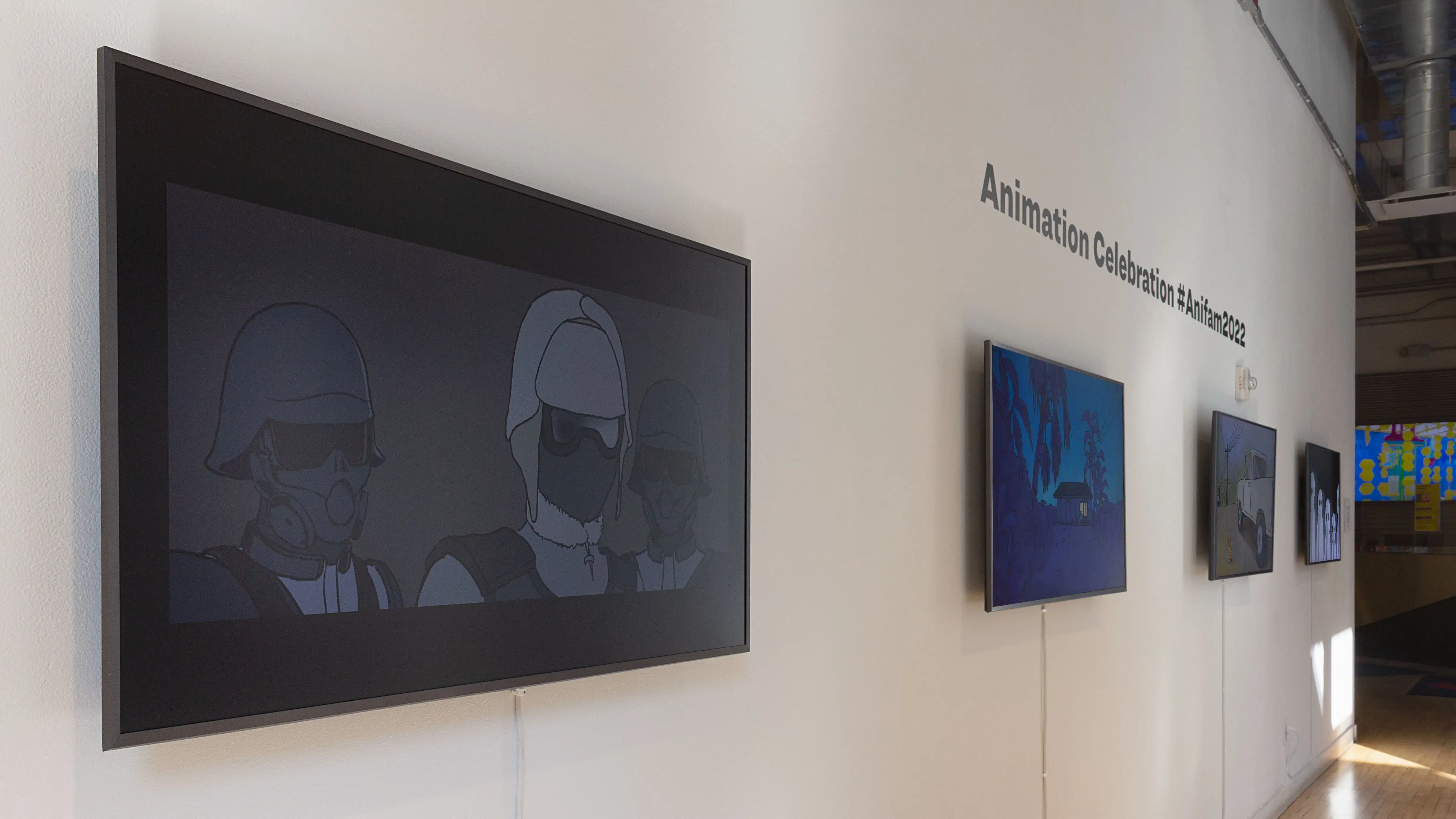 Multiple views of SVA Flatiron Windows and Flatiron Project Space. There are monitors hung in the Windows with films playing and film posters hung in the Flatiron Project Space.