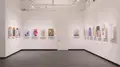 Multiple views of SVA Gramercy Gallery. Posters with illustrations are hung on the walls. 