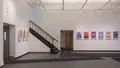 Multiple views of SVA Gramercy Gallery. Posters with illustrations are hung on the walls. 