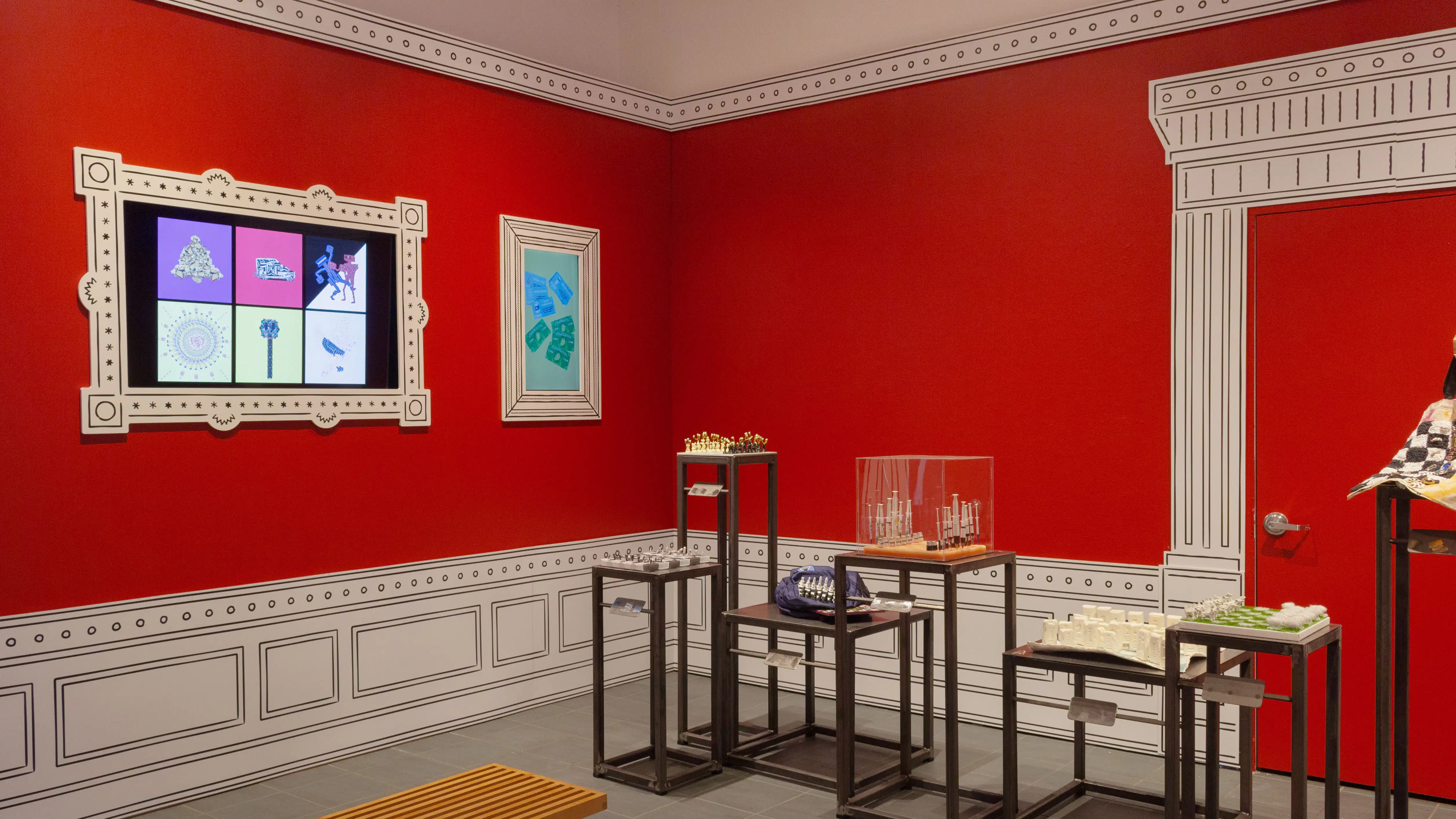 Multiple views of SVA Gramercy Gallery. The lobby is pained red with "Spring Salon" in ornate lettering and the gallery is painted blue. There are monitors in ornate frames playing student work through the gallery. In the center of the lobby and gallery are metal pedestals with student work on them. 