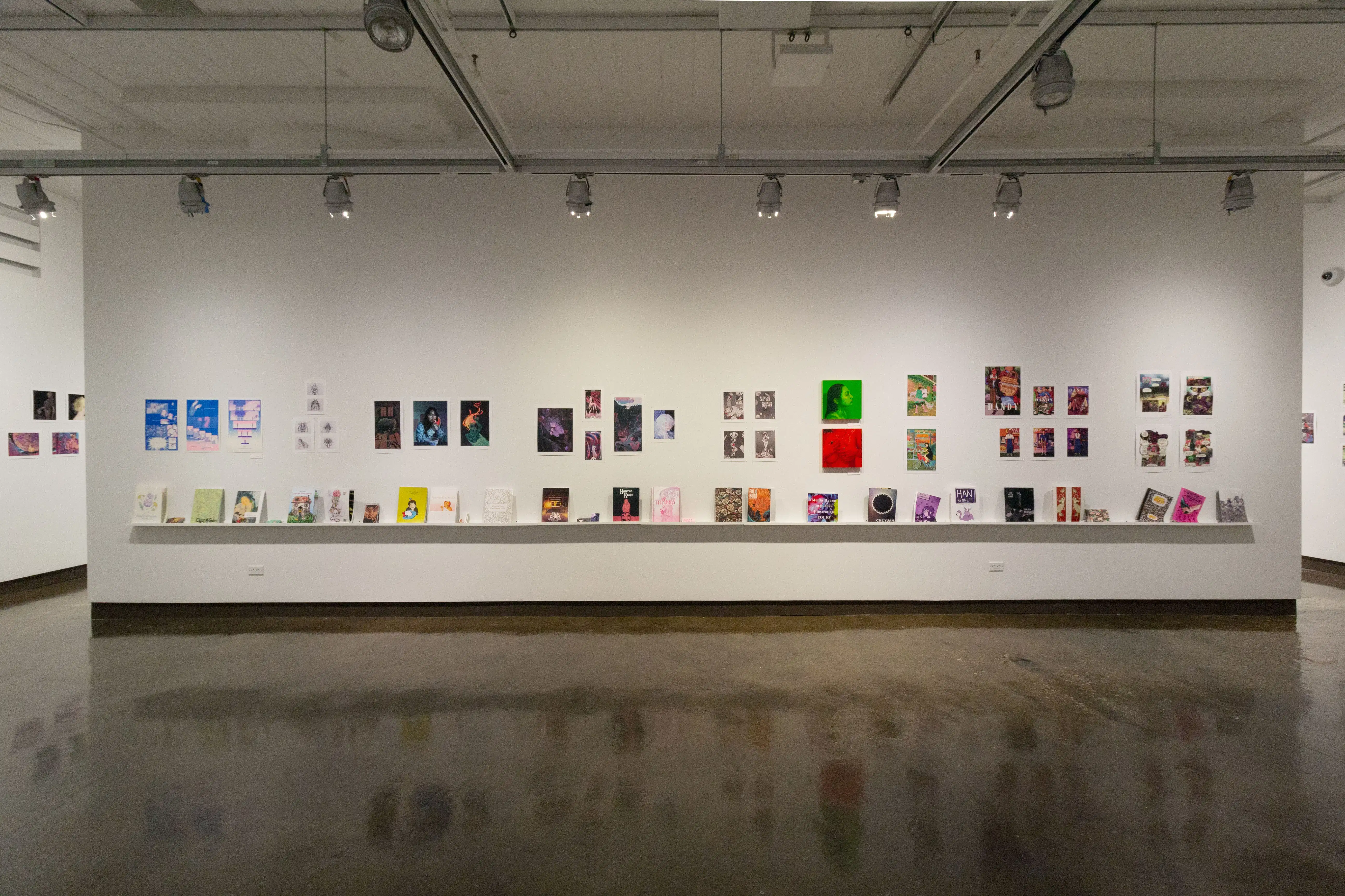 Multiple views of SVA Chelsea Gallery. There is illustrations and paintings hung on the walls. There are multiple shelves throughout the gallery with books places on them.