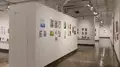 Multiple views of SVA Chelsea Gallery. There is illustrations and paintings hung on the walls. There are multiple shelves throughout the gallery with books places on them.