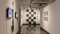 Multiple views of SVA Chelsea Gallery. There are photographs hung on the wall, installations and projections throughout the gallery. 