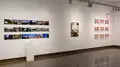 Multiple views of SVA Chelsea Gallery. There are photographs hung on the wall, installations and projections throughout the gallery. 