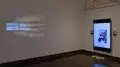 Multiple views of SVA Chelsea Gallery. There are photographs hung on the wall, installations and projections throughout the gallery. 