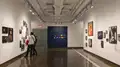 Multiple views of SVA Chelsea Gallery. There are photographs hung on the wall, installations and projections throughout the gallery. 