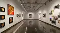Multiple views of SVA Chelsea Gallery. There are photographs hung on the wall, installations and projections throughout the gallery. 