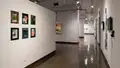 Multiple views of SVA Chelsea Gallery. There are photographs hung on the wall, installations and projections throughout the gallery. 