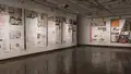 Multiple views of SVA Chelsea Gallery. Posters are hung on the walls. The second gallery has two projections on opposite walls with chairs in the center. 