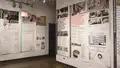 Multiple views of SVA Chelsea Gallery. Posters are hung on the walls. The second gallery has two projections on opposite walls with chairs in the center. 