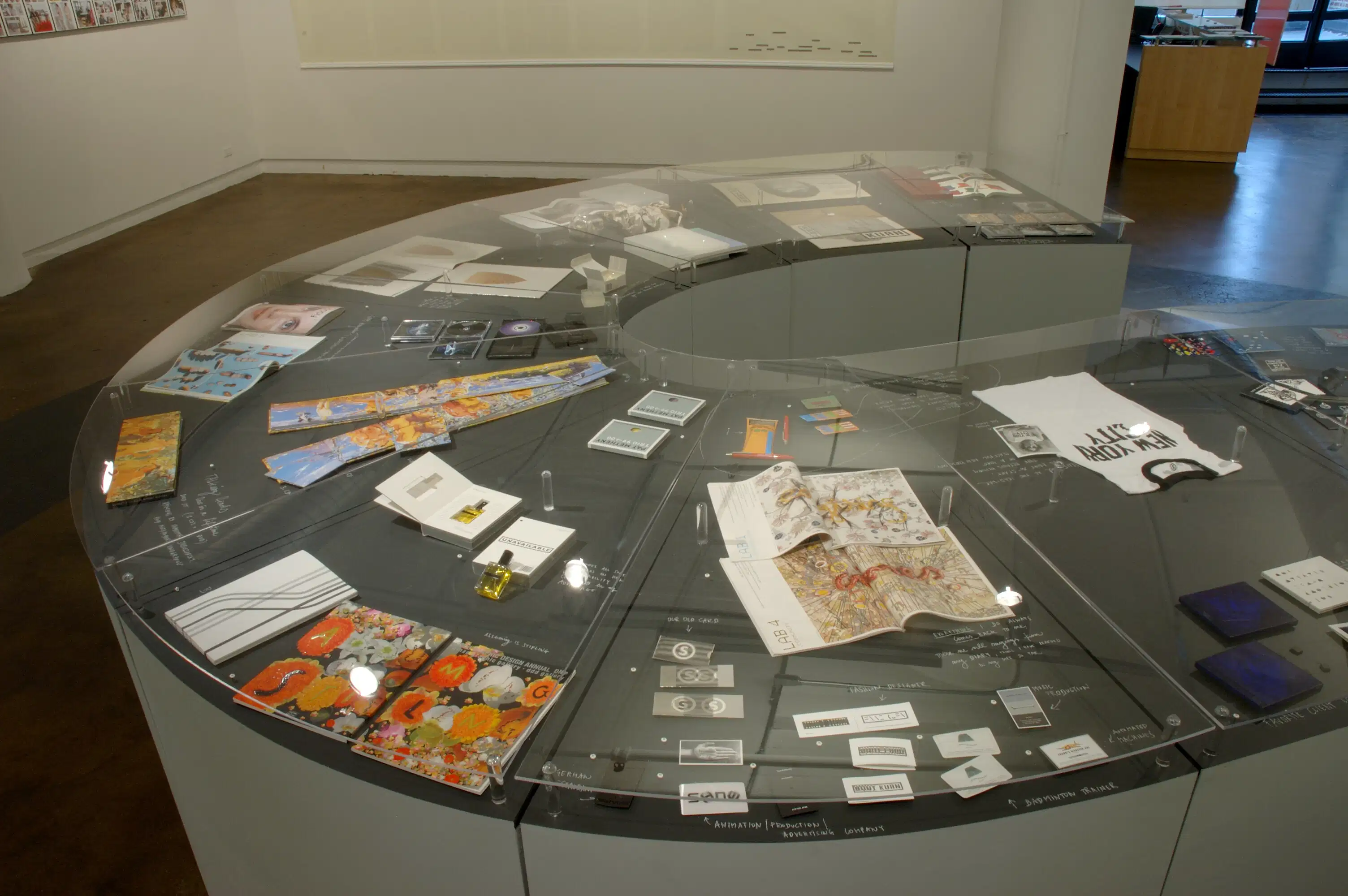A u-shaped display case with varying papers.