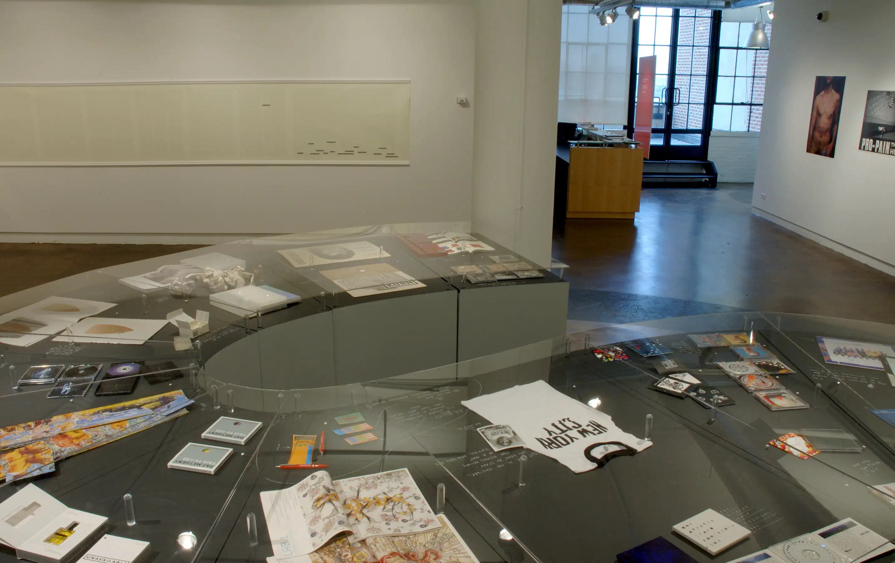 Multi functional office area to include many different working projects. Art mod posh, Screen arts multi media art projects. On a round glass table.