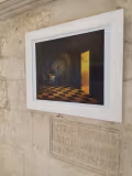 Another framed work shows a dark room with a checkered floor and an open doorway.