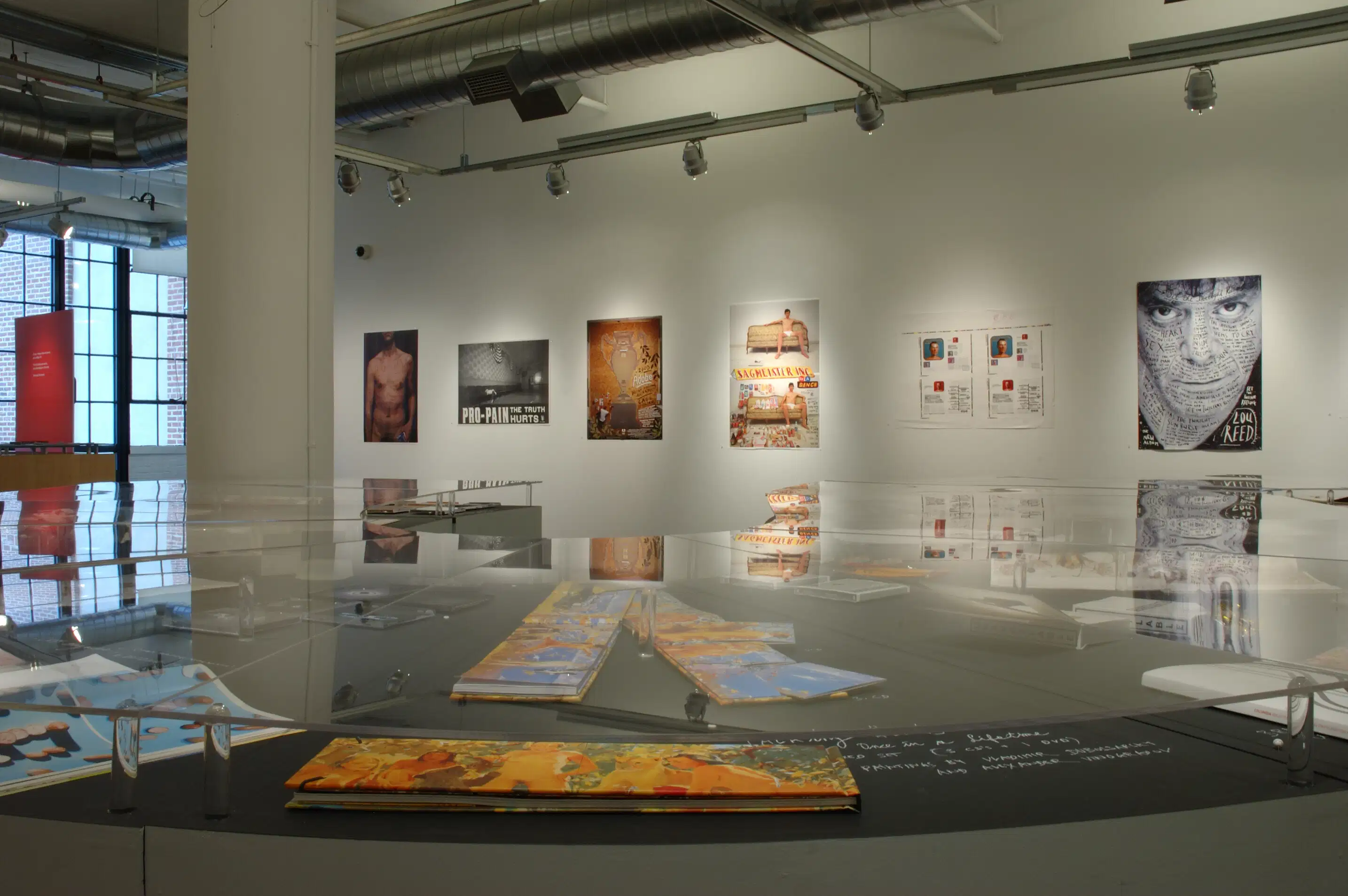 A room at an art gallery.  Various works of art are on display.