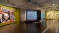Photograph from inside SVA Chelsea Gallery with advertising graphics hung on walls.