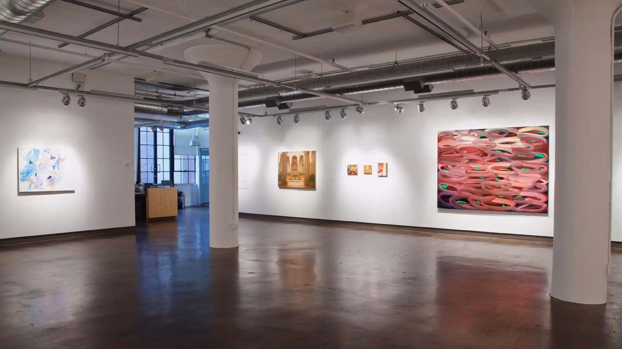 Exhibition photograph of “Between Picture and Viewer," showing paintings on two walls. On left is an abstract in pastels, on right are four photorealistic paintings in muted earth tones, and on far right is a large abstract painting in red and green.