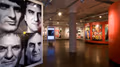 Photograph from inside SVA Chelsea Gallery with advertising graphics hung on walls.