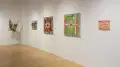 Installation image featuring three mixed media 2d works and two textile works.