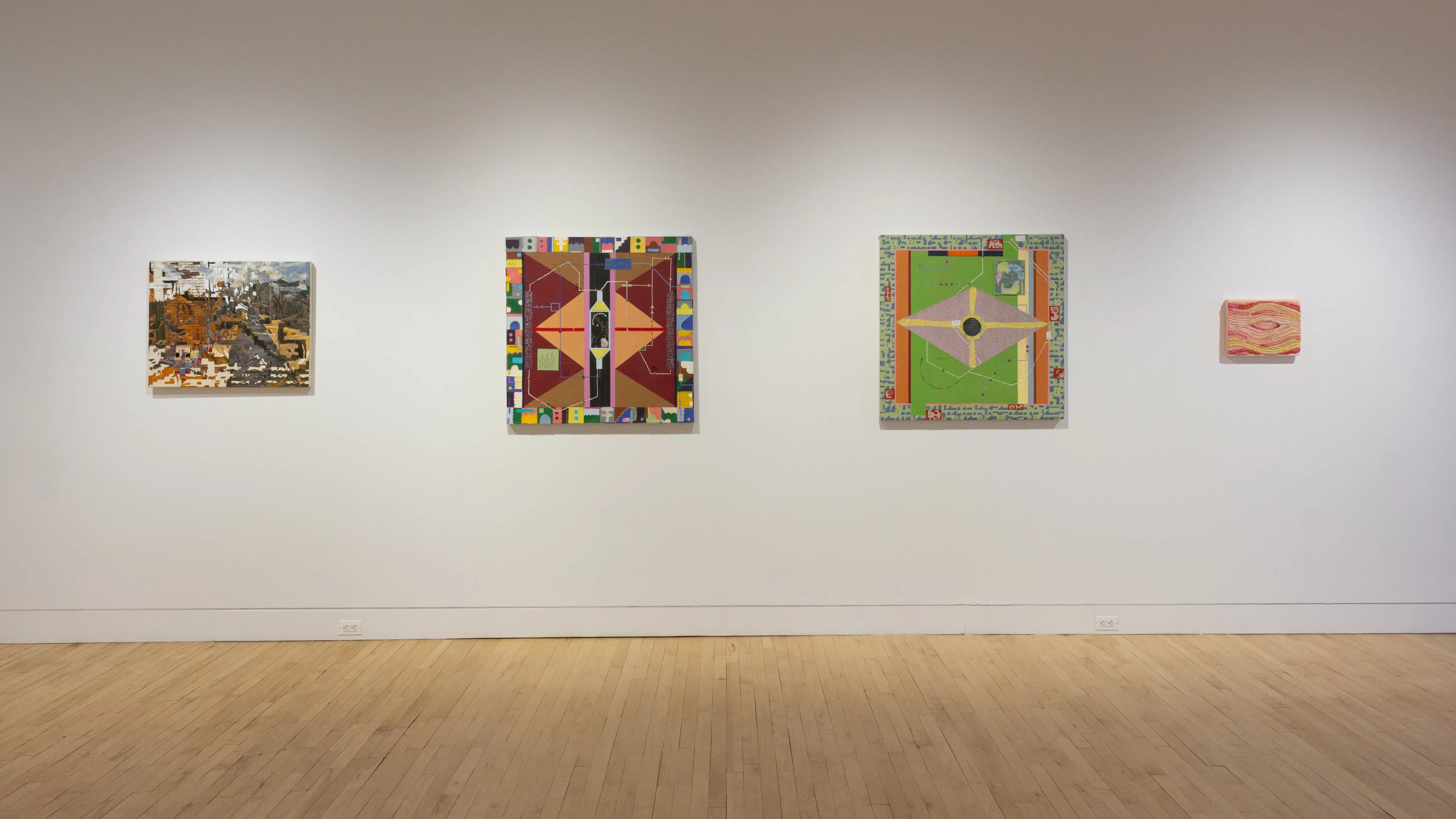 Installation image featuring three mixed media 2d works and one textile work.