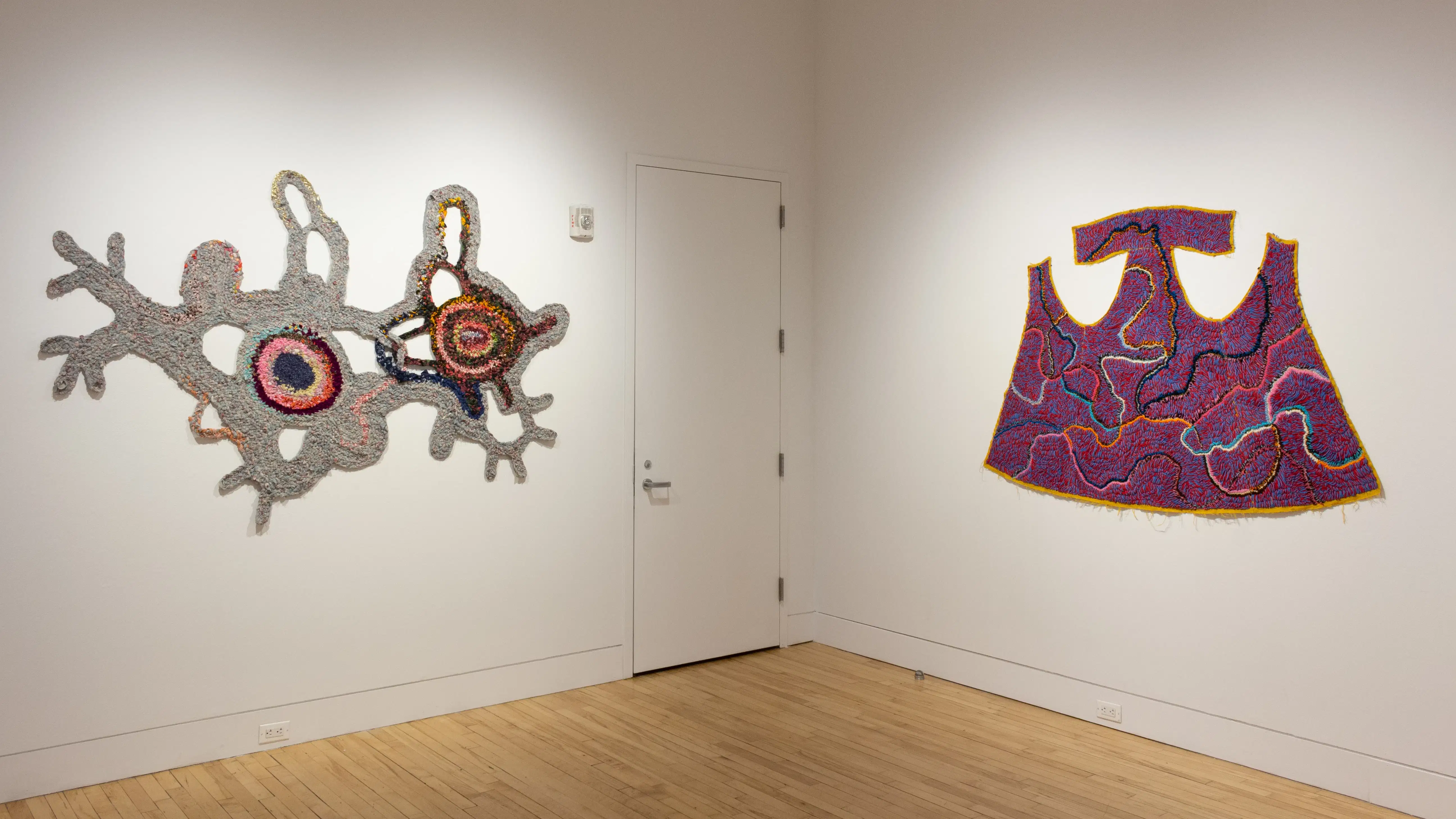 Installation image featuring two textile works.