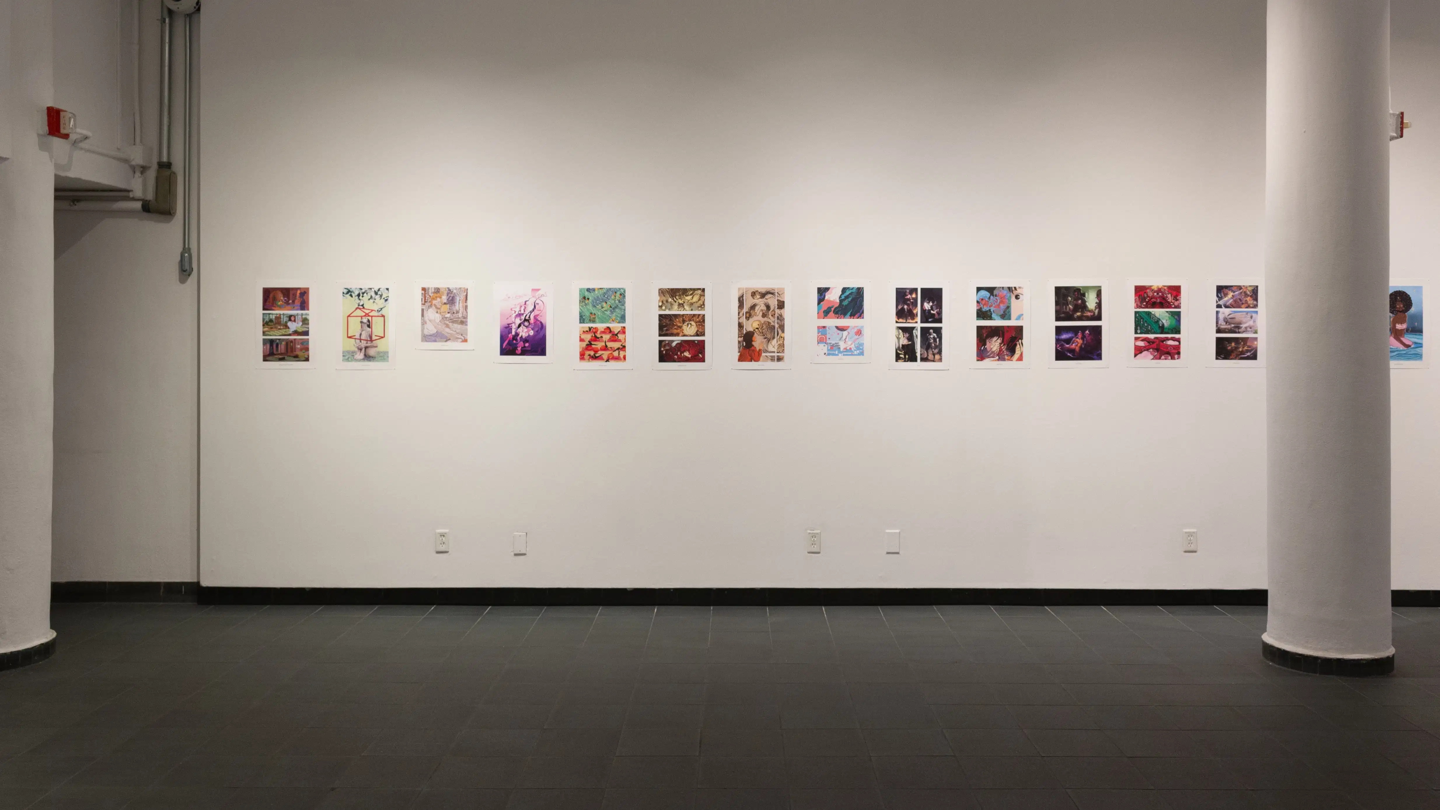 Install image showing a wall with many prints lining the walls in a row, a column on the right and a doorway on the left.