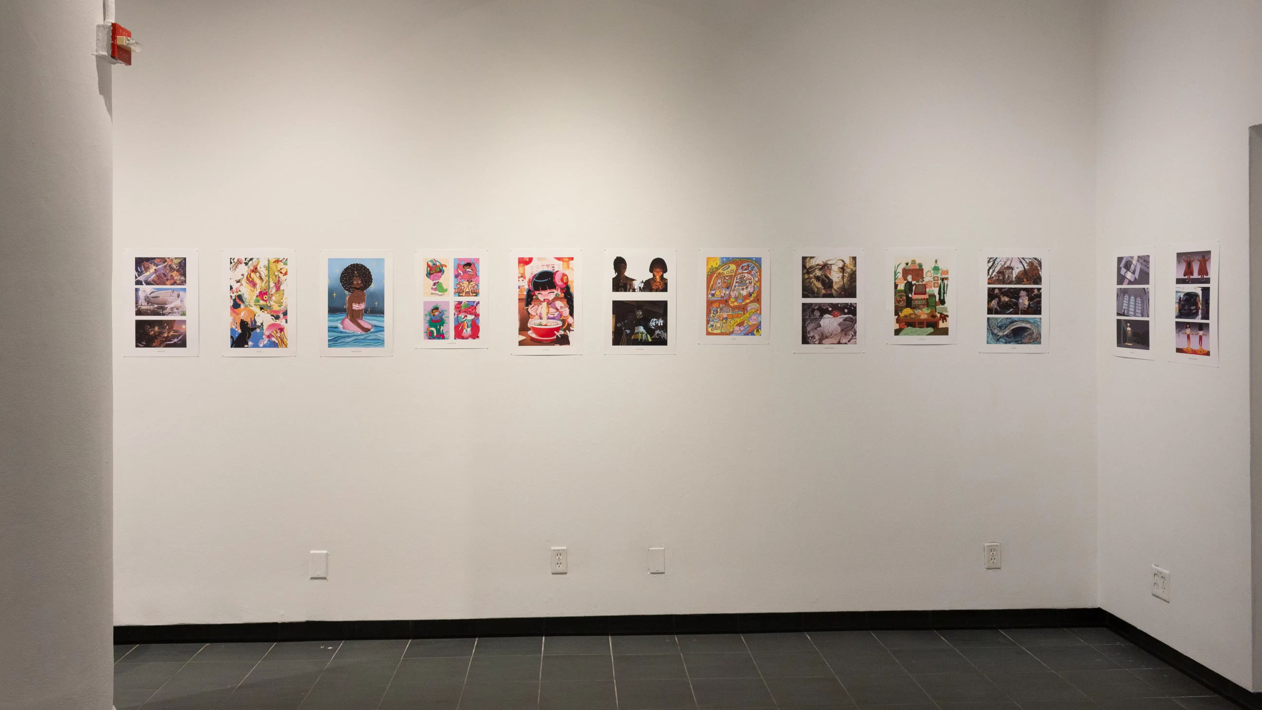 Install image showing a wall with many prints lining the walls in a row, a column on the left and a doorway on the right.