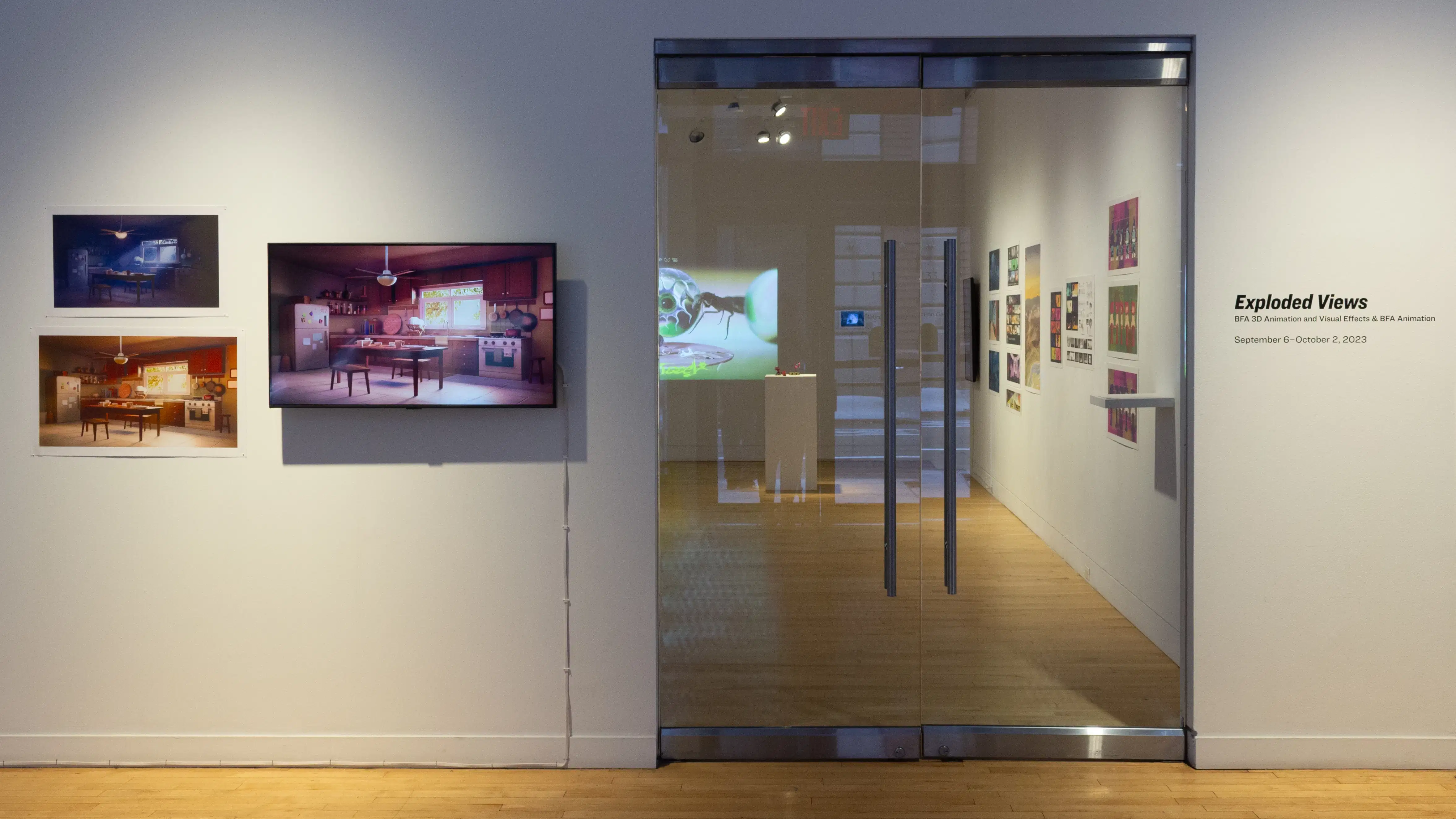 Install image showing glass gallery doors with a monitor and two prints to the left.