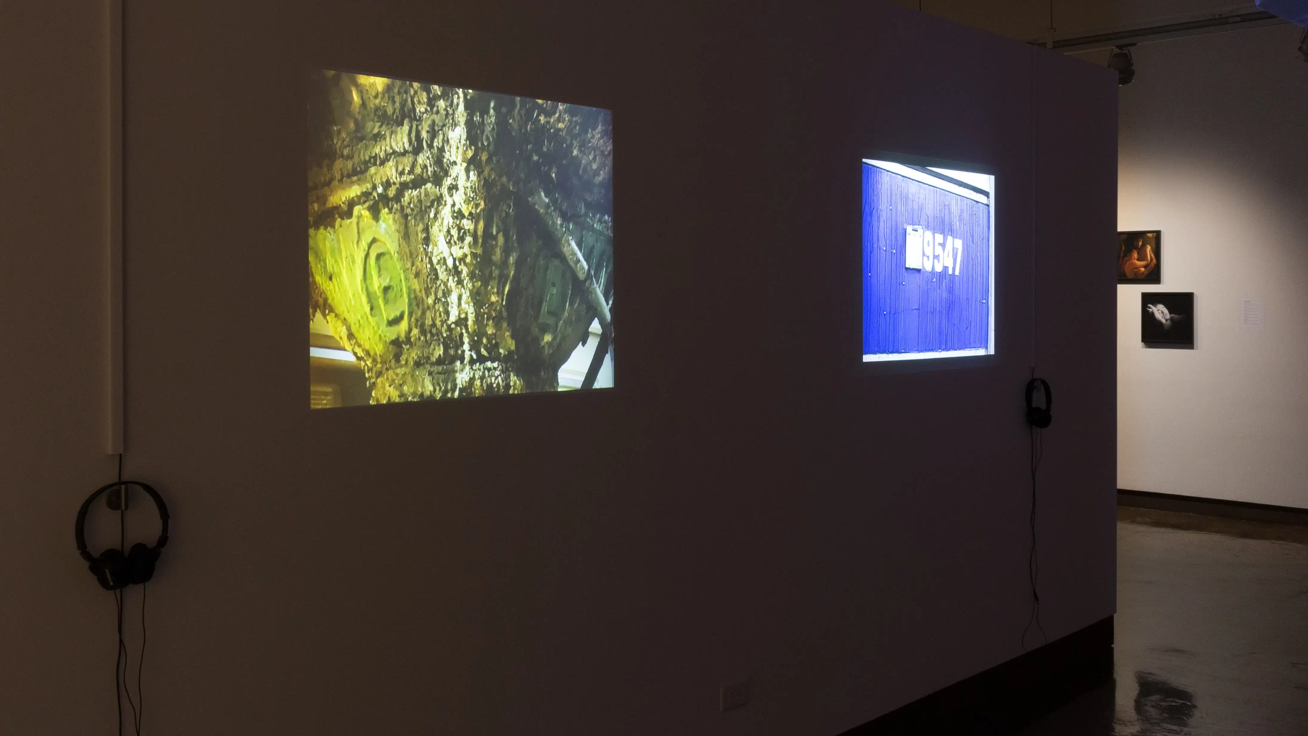 Another two projections in the left hallway show images of text and numbers seen in daily life.