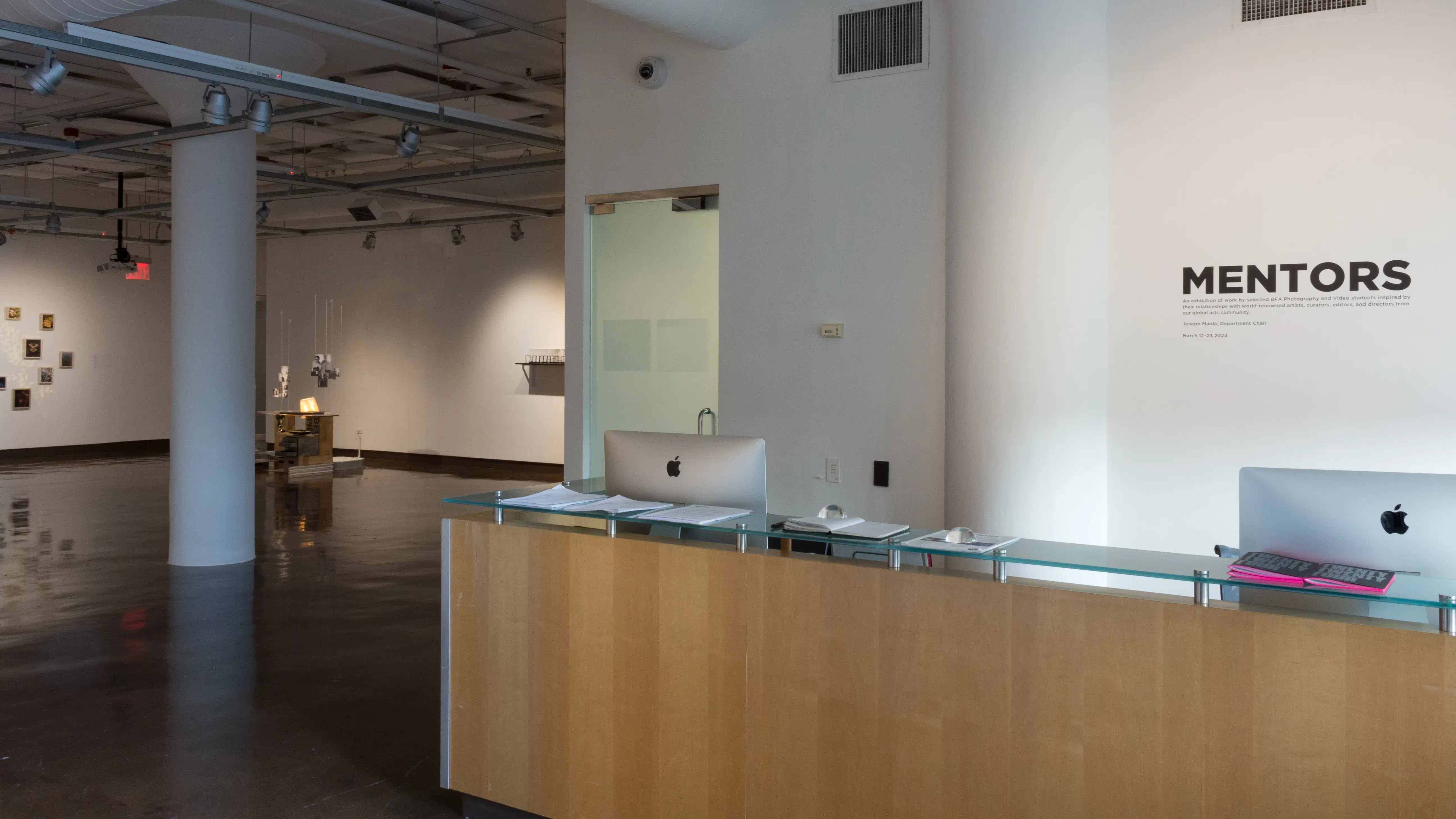Vinyl signage over the SVA Chelsea Gallery front desk reads “Mentors”.