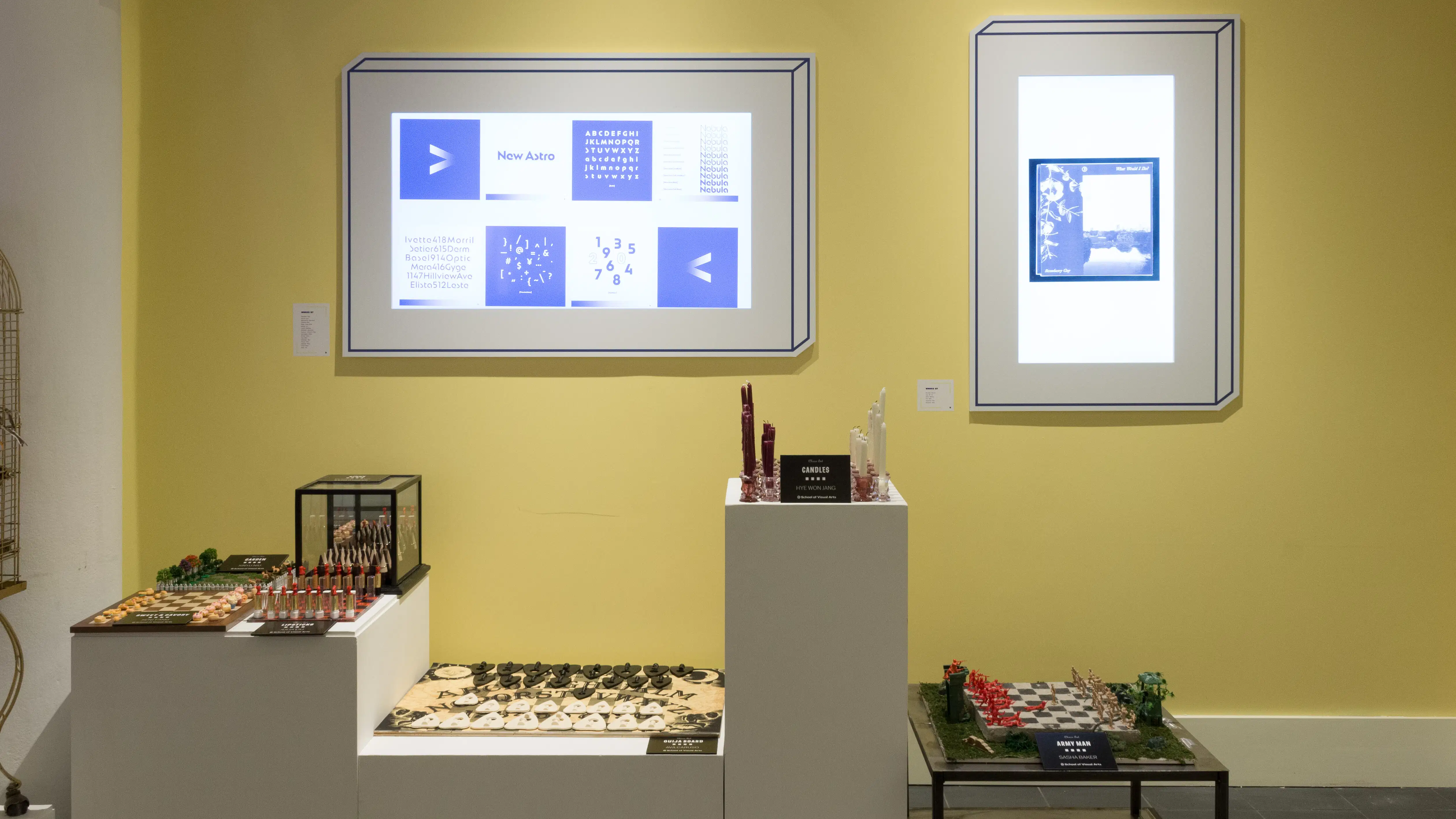 A third view of the leftmost wall. Several pedestals of varying heights with chess boards are against a wall with two monitors.