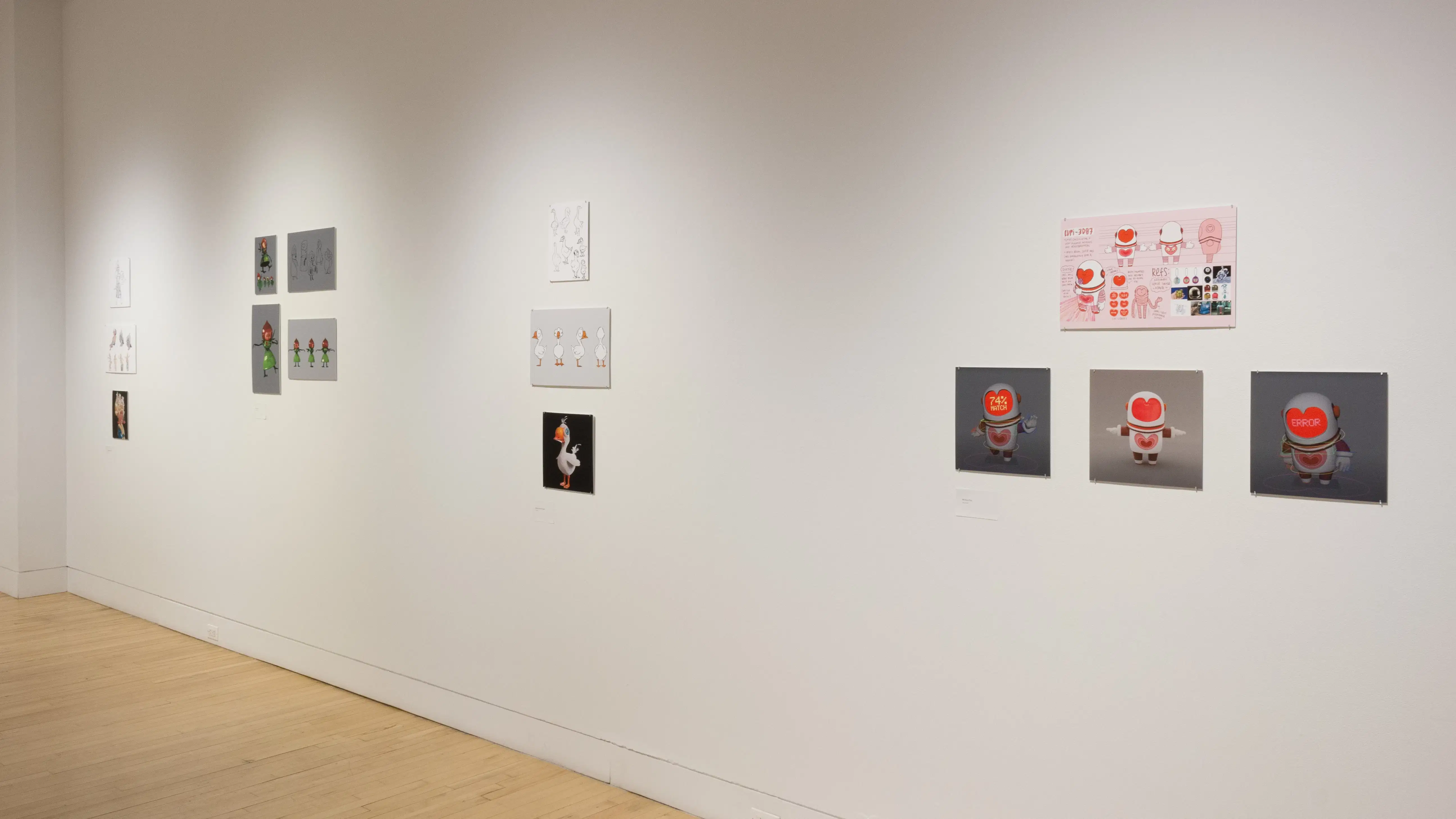 Angled view of four student works, showing four installations of printed mockups of animated characters.
