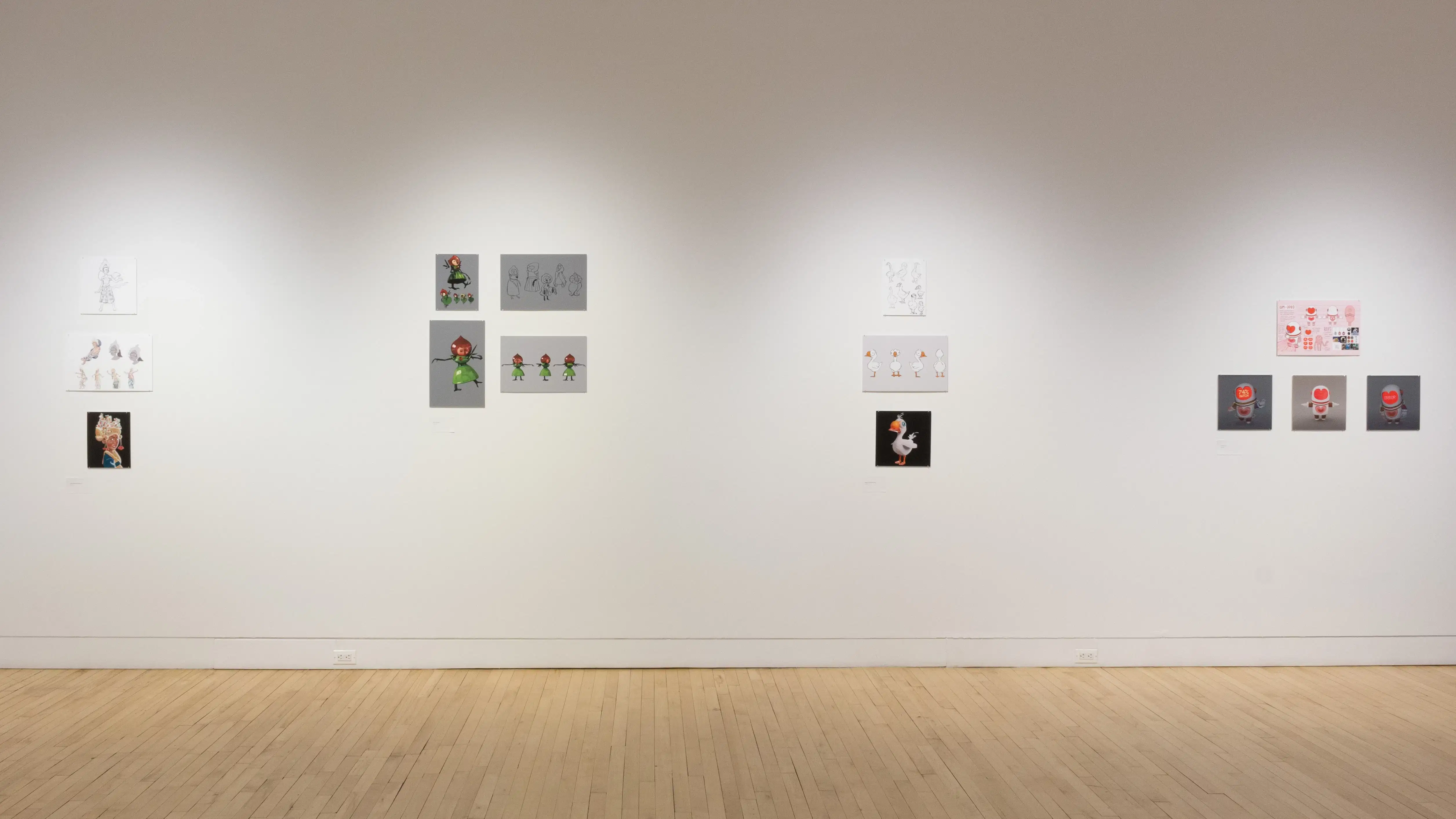 Front view of four student works, showing printed mockups of animated characters.