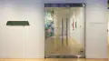 A view of the entrance of the SVA Flatiron Gallery highlights a single sculpture piece and vinyl signage that reads “Traces: Memory, Nature and the Body, SVA’s Artist Residency Programs Alumni Exhibition” 