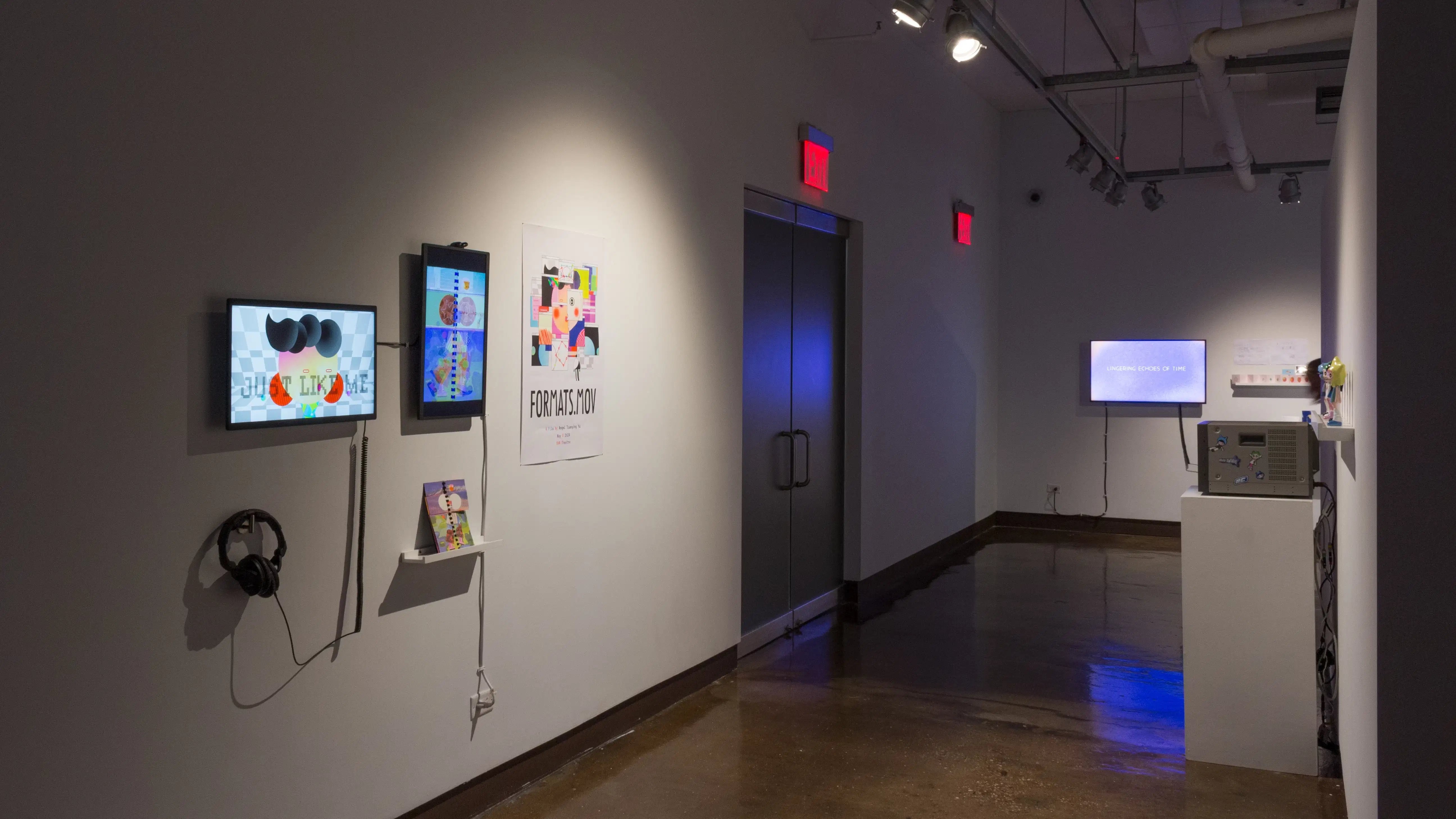 Angled image showing several monitors playing various animated films, with two doors in the middle ground.