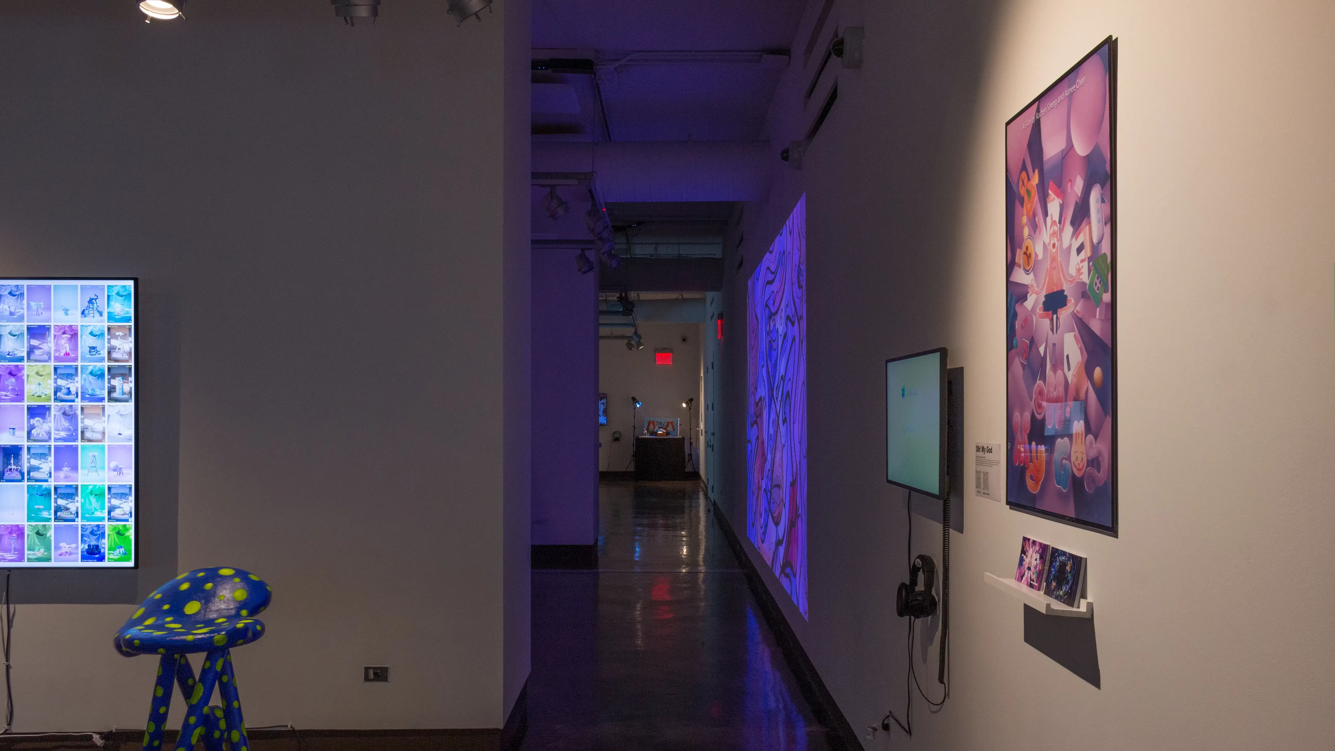 A long hallway to the right of several gallery spaces, with projections and installations visible in the background.