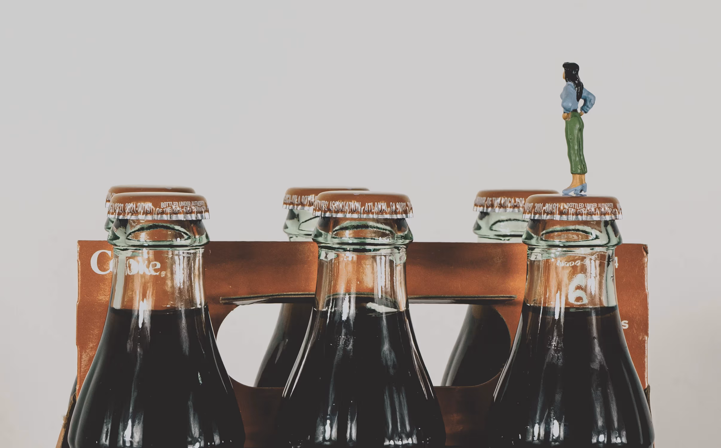 Still life, miniature standing on Coca-Cola product