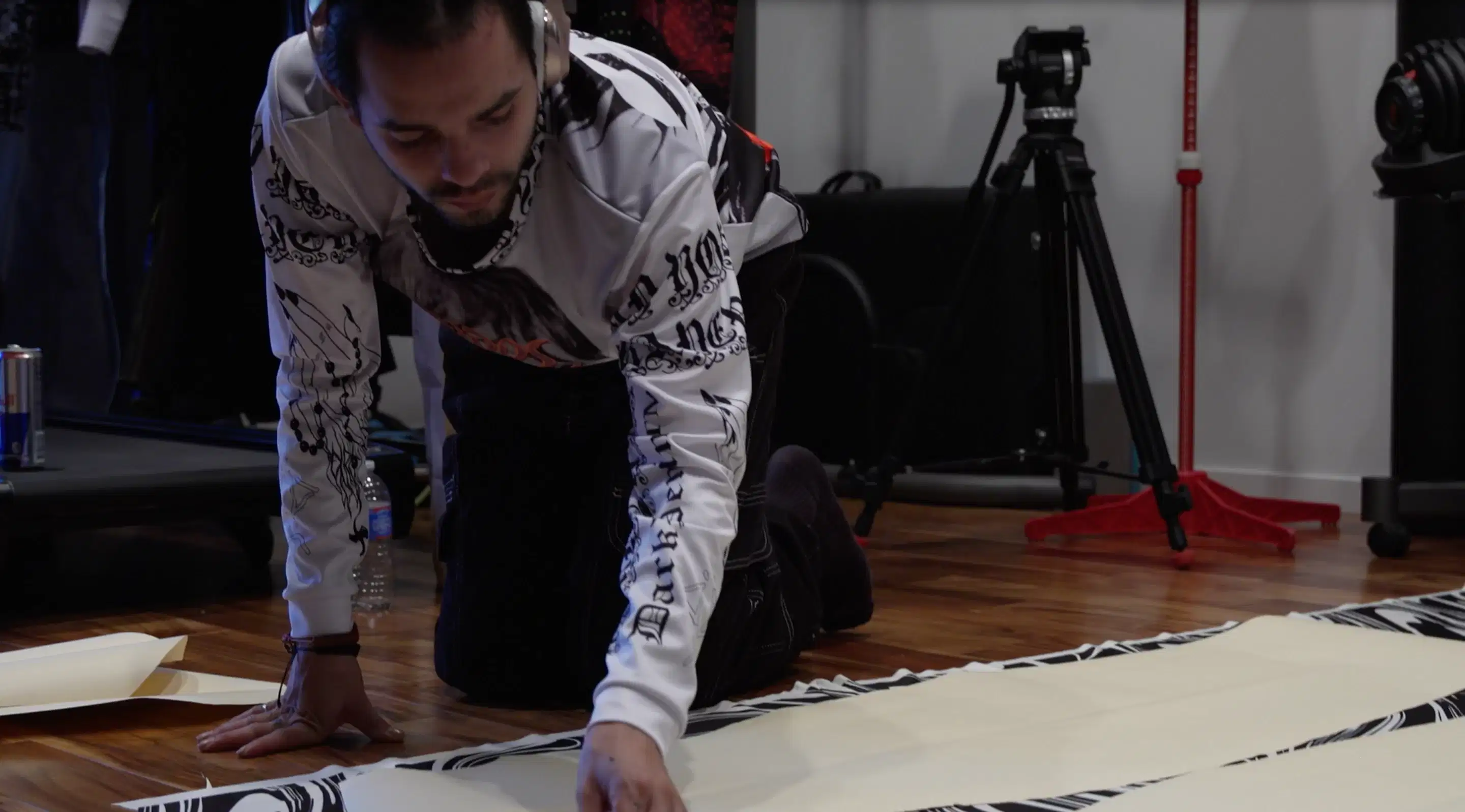 person leaning on ground, making a garment 