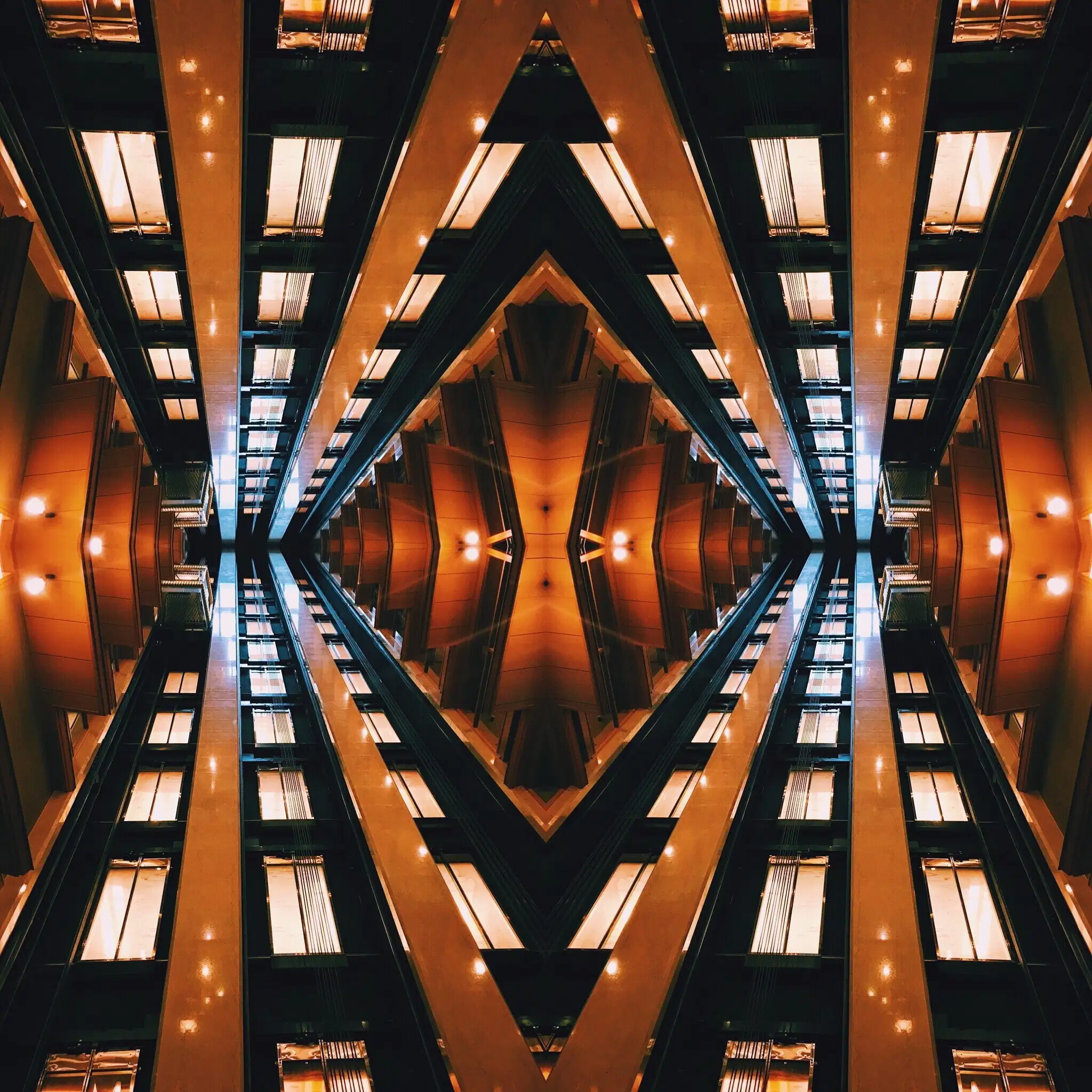 Photograph of repeating windows in an orange and black hallway.