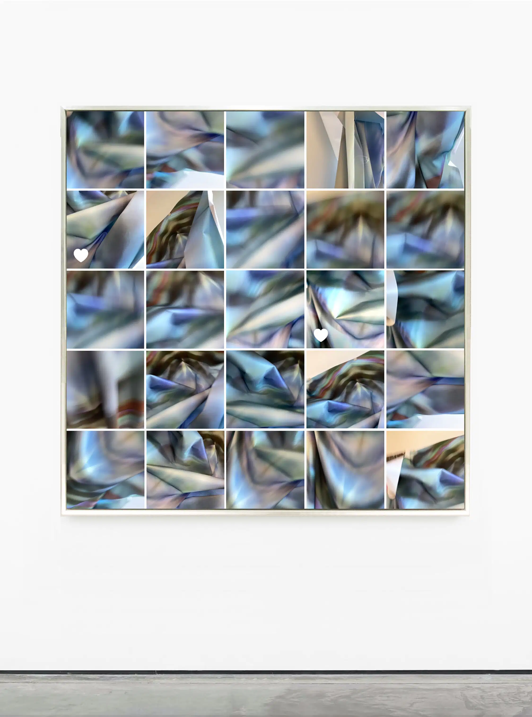 Camera roll of images of a blue and white scarf presented in a grid on a wall.