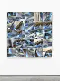 Camera roll of images of a blue and white scarf presented in a grid on a wall.