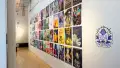 Installation image showing a hall lined with posters.