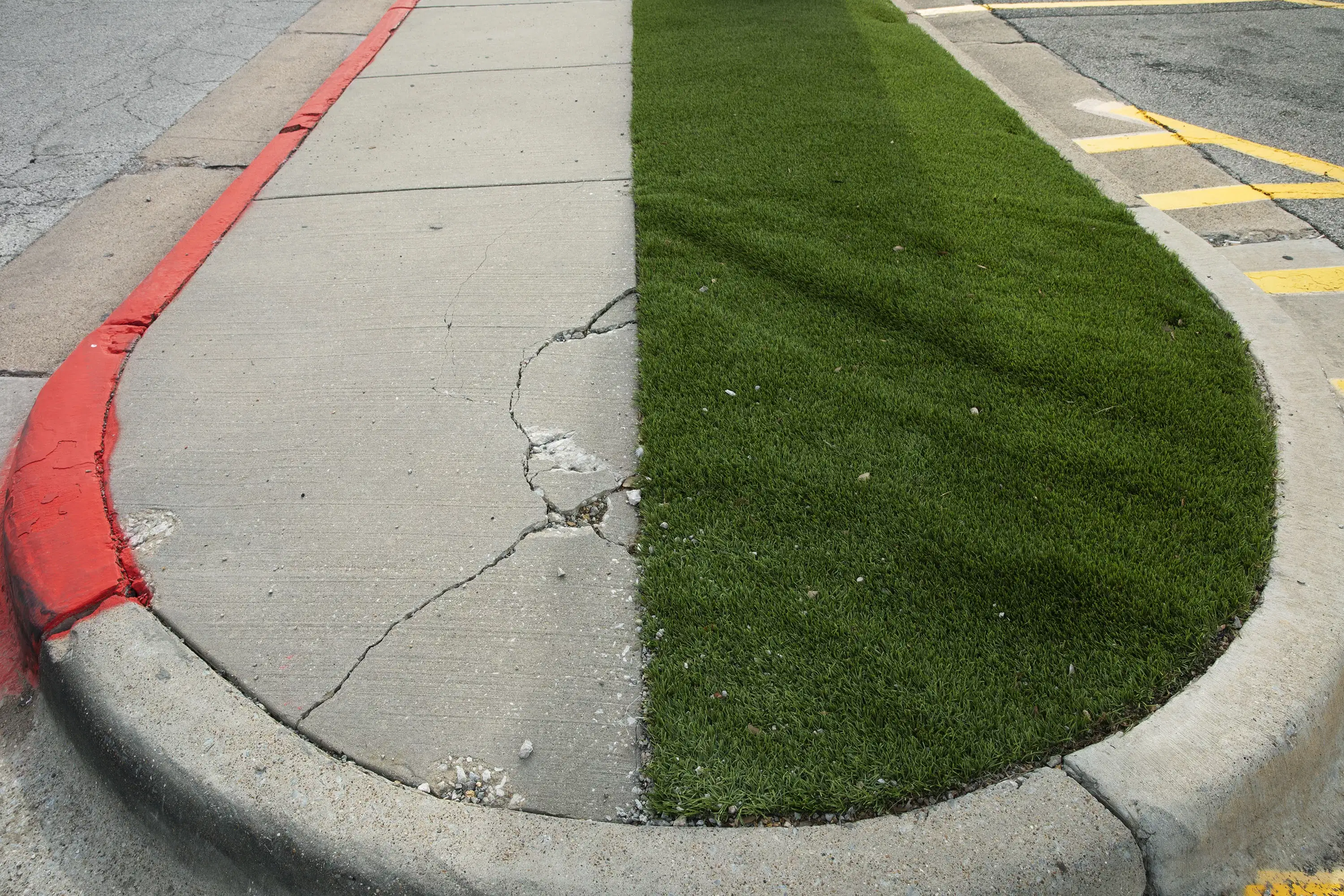 A color photograph of a half-turfed traffic island.