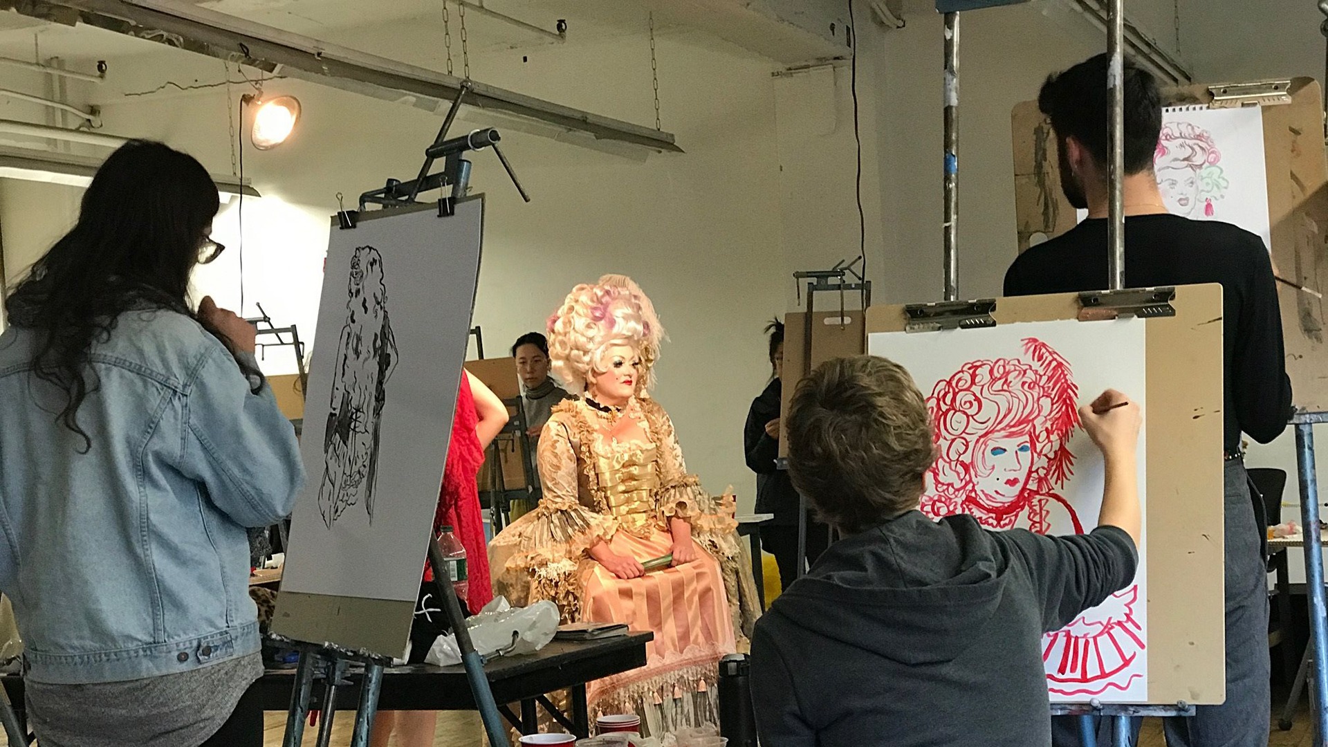 Woman drawing a model with easles