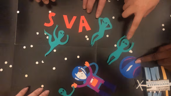 Still from stop-motion animation featuring paper cutouts of aliens and a cat-stronaut