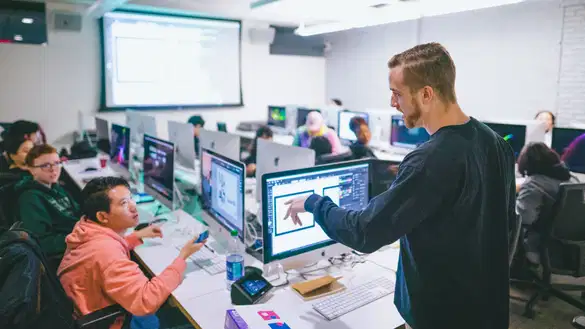 Student and teacher discussing during class in the Digital Imaging Center.