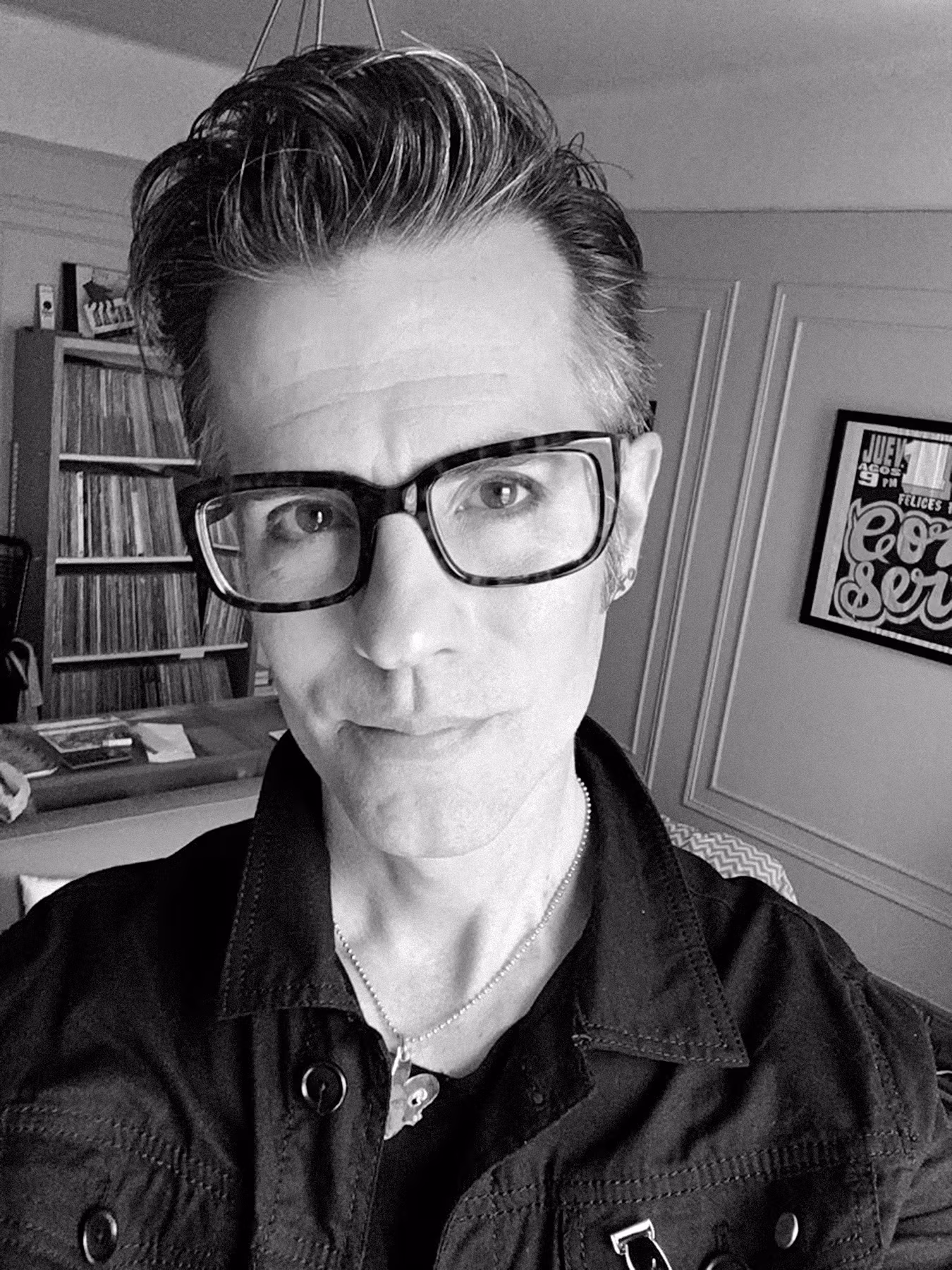 Faculty member Joe Newton wearing black rimmed glasses and a black shirt.