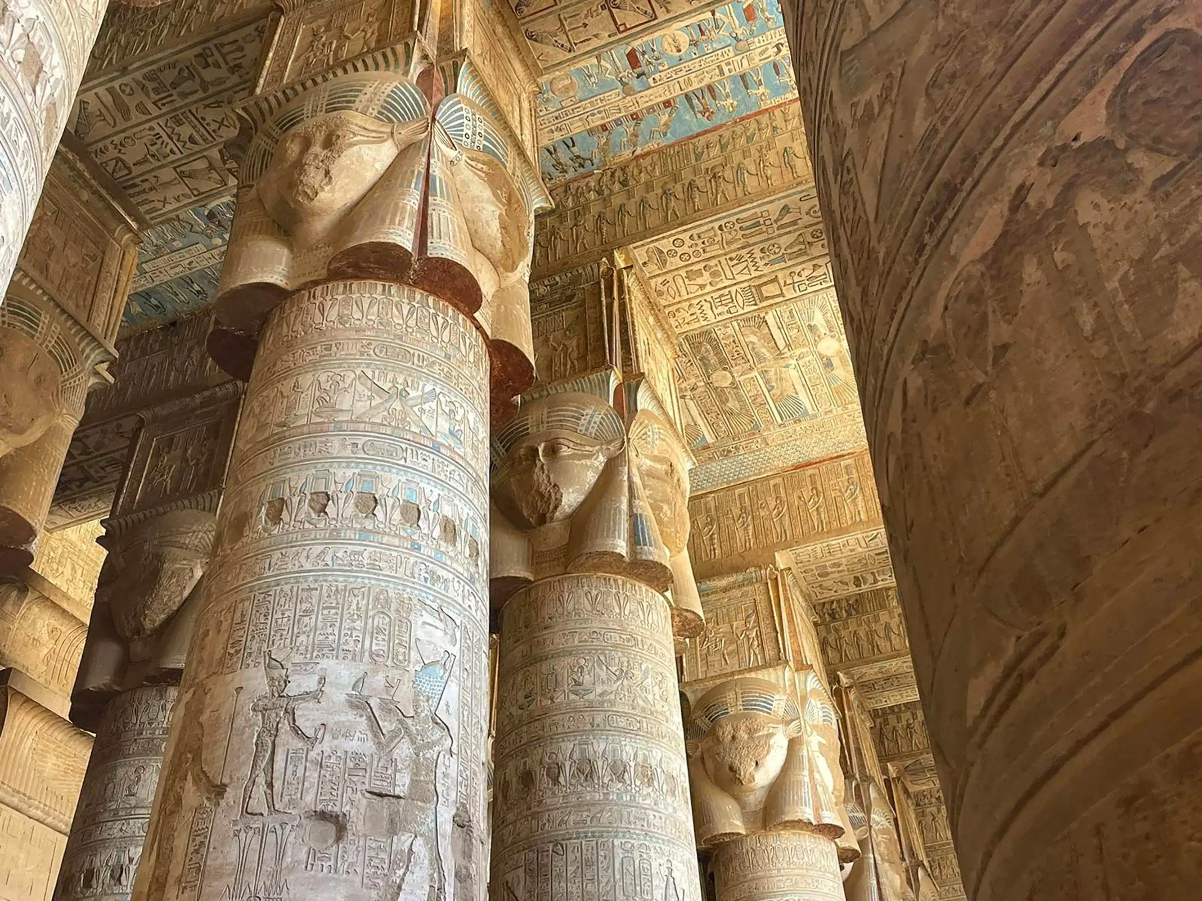 Pilars filled with detailed and ornate hieroglyphics in buildings in ancient Egypt. 