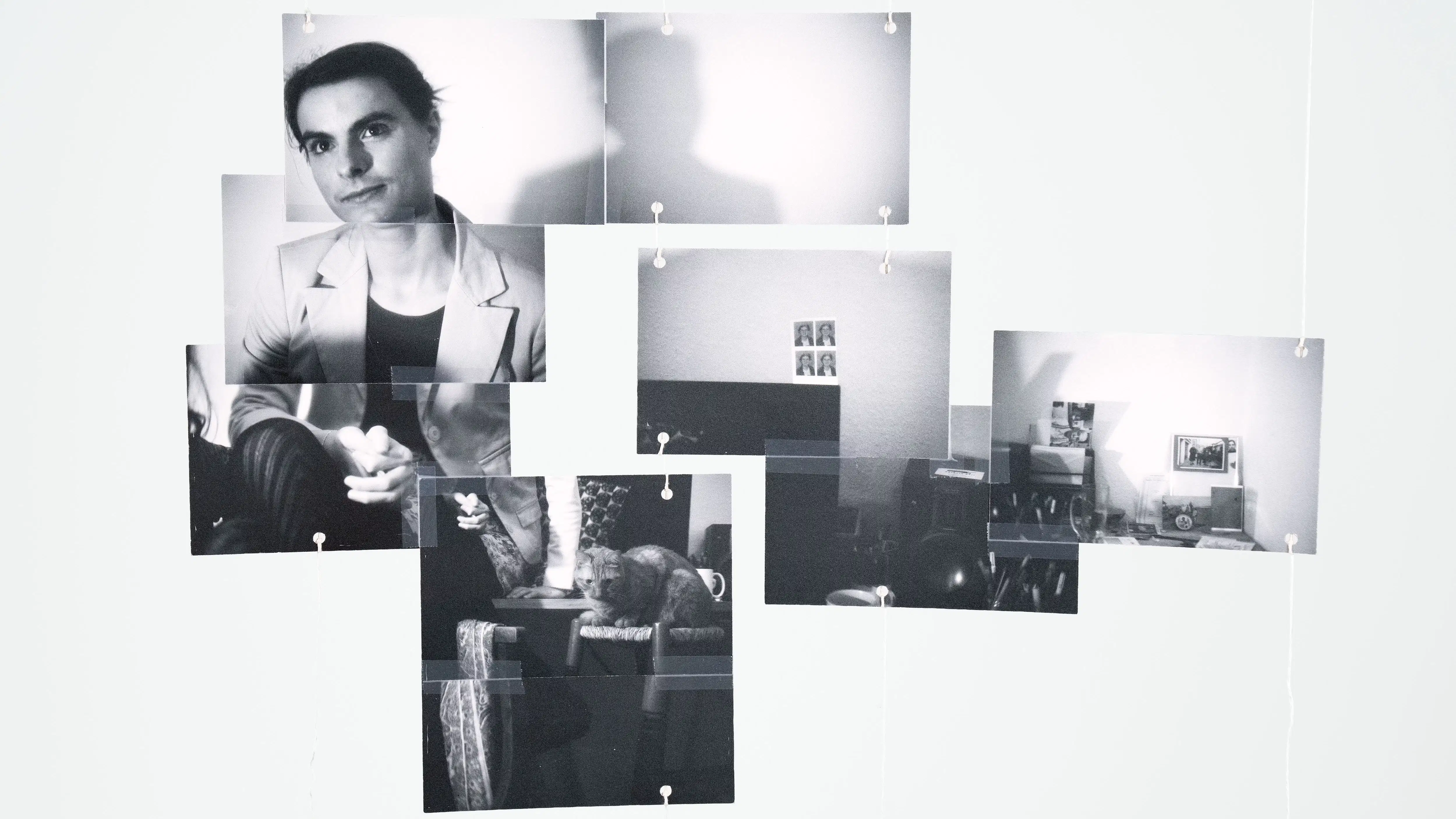 black and white photos hanging from wire