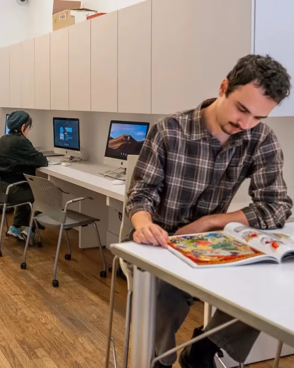 People congregating in an open plan, community oriented lounge.
