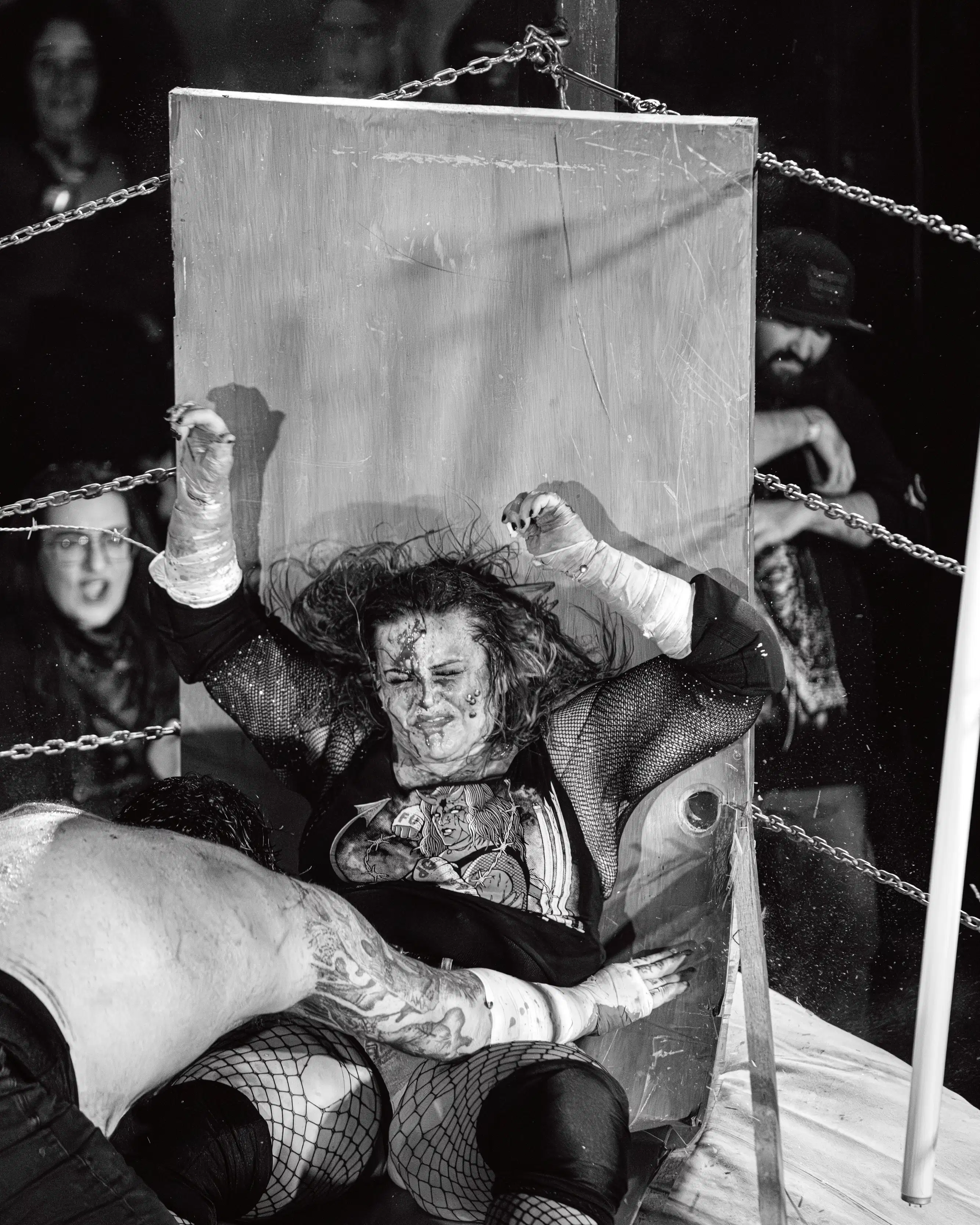 a wrestler bodyslams another through a table